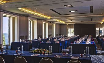 a large conference room with rows of chairs and tables set up for a meeting or event at Daios Cove Luxury Resort & Villas