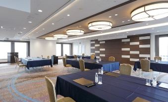 A spacious room is arranged with long tables and chairs for an event or conference at Keio Plaza Hotel Tokyo