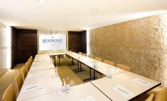 a conference room with a long table and chairs , set up for a meeting or event at Residence Hotel