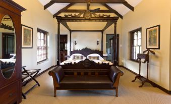 a spacious bedroom with two beds , one on the left and one on the right side of the room at Schoone Oordt Country House