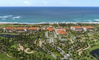 aerial view of a resort with multiple buildings and a golf course , surrounded by the ocean at Shangri-La's Hambantota Golf Resort and Spa, Sri Lanka