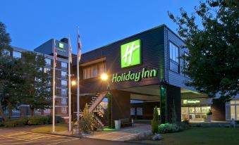 "a large hotel with a green sign that says "" holiday inn "" on the front of the building" at Holiday Inn Washington