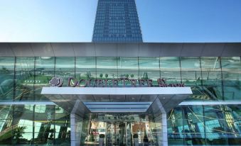 "a modern building with a large glass facade and the words "" universal bank "" written in front" at DoubleTree by Hilton Istanbul-Avcilar