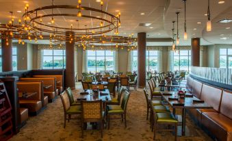 a large dining room with multiple tables and chairs arranged for a group of people to enjoy a meal together at Holiday Inn Owensboro Riverfront