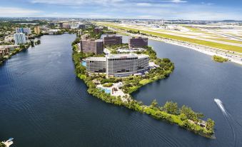 a bird 's eye view of a large building surrounded by water and surrounded by land at Hilton Miami Airport Blue Lagoon