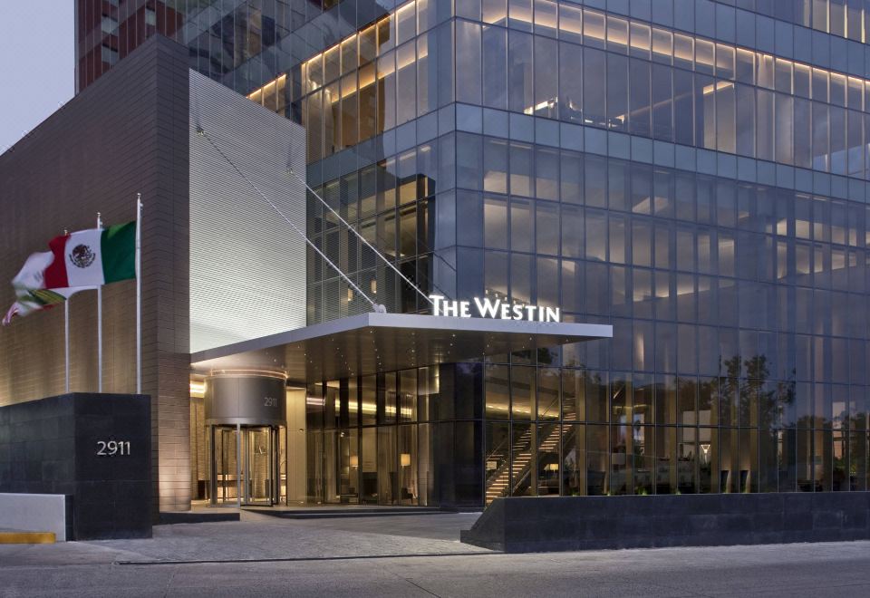 "the westin hotel is shown in front of a modern building with glass windows and the sign "" the westin .""." at The Westin Guadalajara