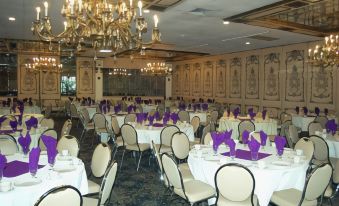 a large banquet hall with numerous dining tables and chairs arranged for a formal event at Best Western Plus Wilkes Barre Center City