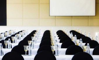 a conference room set up for a meeting , with rows of chairs arranged in front of a long table at Robinson Khao Lak