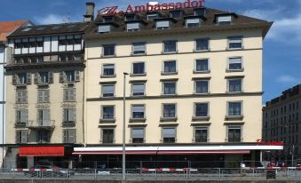 "a large white building with a red awning and the words "" the ambassador "" written on it" at The Ambassador