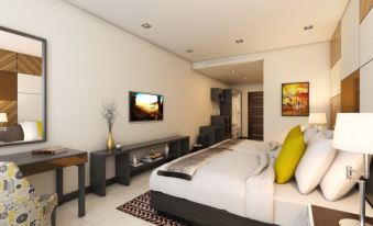 a modern bedroom with a king - sized bed , a flat - screen tv mounted on the wall , and a desk at Summit Hotel Tacloban