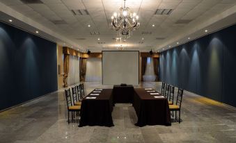 a large conference room with several tables and chairs arranged for a meeting or event at Hotel San Sebastian
