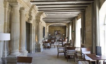 a large , open dining room with multiple tables and chairs arranged for a group of people at Parador de Argomaniz