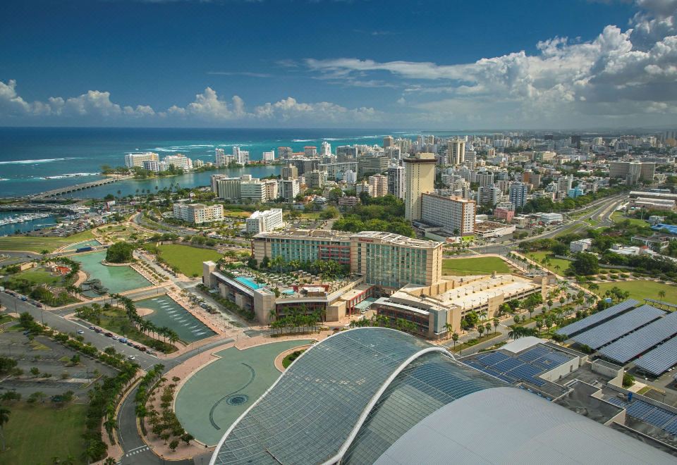 a bird 's eye view of a city with a large building , surrounded by water and other buildings at Sheraton Puerto Rico Resort & Casino