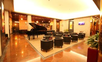 a room with a grand piano and several chairs arranged in a circular pattern , creating a grand piano - like atmosphere at Hotel Diplomatic
