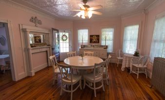 a dining room with a round table surrounded by chairs , and a ceiling fan hanging from the ceiling at Inn at Tyler Hill