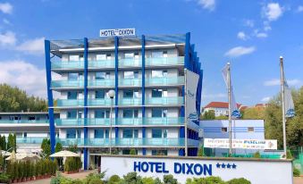 "a large blue building with the words "" hotel dixon "" on its facade , located in a city" at Hotel Dixon