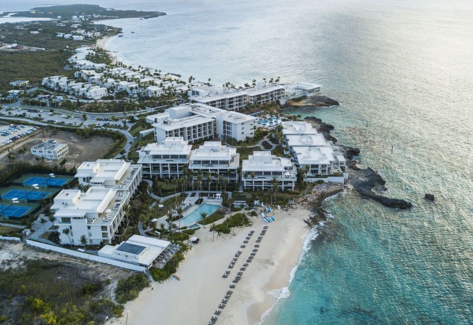 an aerial view of a beachfront resort with multiple buildings and a swimming pool at Four Seasons Resort and Residence Anguilla