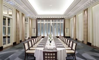 a large conference room with a long table and several chairs arranged for a meeting at Hotel the Peninsula Paris