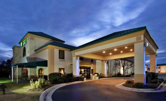 "a large building with a green roof and the words "" holiday inn express "" on it" at Spring Lake Inn & Suites - Fayetteville