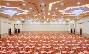 a large , empty conference room with a carpeted floor and multiple rows of chairs arranged in front of it at Raia Hotel & Convention Centre Alor Setar
