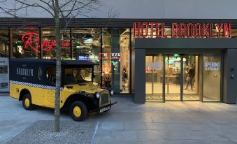 "a yellow taxi cab is parked in front of a hotel with the sign "" hotel brooklyn .""." at Hotel Brooklyn Manchester