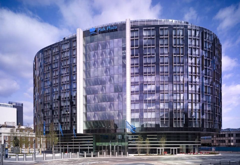 a modern , black and white building with large windows and a blue flag on the front at Park Plaza Westminster Bridge London