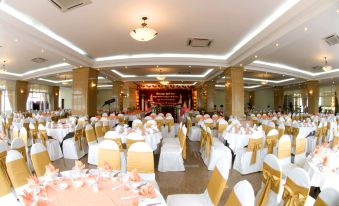 a large banquet hall filled with tables and chairs , ready for a wedding reception or other event at Seagull Hotel