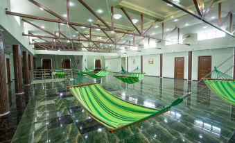 a large room with several hammocks hanging from the ceiling , creating a unique and unconventional space at Well Hotel and Spa
