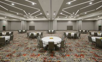 a large banquet hall with multiple round tables and chairs arranged for a formal event at Courtyard Austin Pflugerville and Pflugerville Conference Center