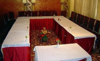 a conference room set up for a meeting , with tables and chairs arranged in an orderly fashion at Indiana Hotel