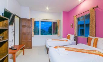 a pink bedroom with two beds , one on the left and one on the right side of the room at Aurora Resort Chiangdao