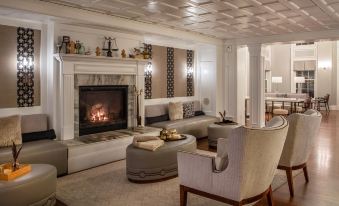 a living room with a large fireplace and white couches , creating a warm and inviting atmosphere at The Equinox