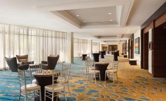 a large , empty banquet hall with numerous tables and chairs set up for an event at Hilton Miami Airport Blue Lagoon