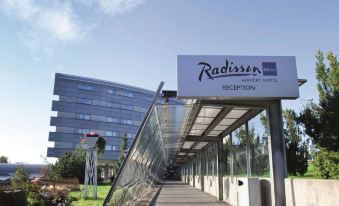 "a modern building with a glass curtain and a sign that says "" radisson ""." at Radisson Blu Airport Hotel, Oslo Gardermoen