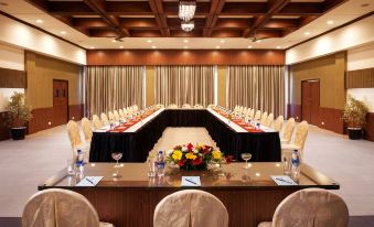 a conference room set up for a meeting , with chairs arranged in a semicircle around a long table at Sterling Munnar