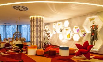 a brightly lit room with various items on display , including chairs , ottomans , and other furniture at Hard Rock Hotel Ibiza