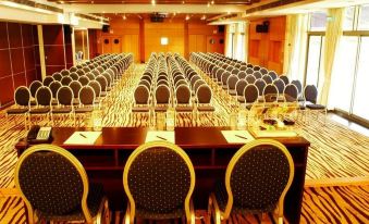 a large conference room with rows of chairs arranged in a semicircle , and a podium at the front of the room at Radisson Blu Hotel, Bamako