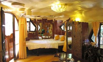 a cozy bedroom with a large bed and a canopy , creating a warm and inviting atmosphere at Crazy House