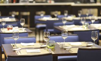 a dining room with tables and chairs set up for a meal , featuring wine glasses and silverware at Courtyard Toluca Tollocan