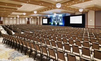 a large conference room with rows of chairs arranged in front of a stage , ready for an event at The Westin Chicago North Shore