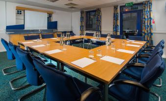 a conference room set up for a meeting , with chairs arranged in a square formation at Holiday Inn Express Droitwich Spa