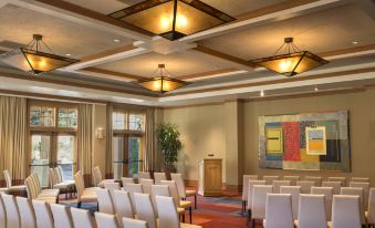 a large conference room with multiple chairs arranged in rows , and a podium at the front of the room at CordeValle