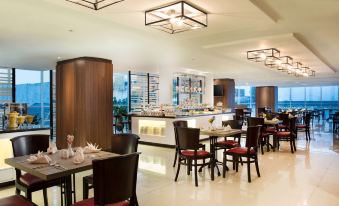 a modern restaurant with a long dining table and chairs , as well as a bar area at Best Western Premier la Grande Hotel