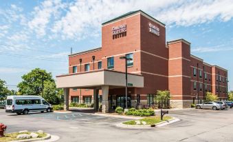 "a red brick building with a sign that reads "" comfort suites "" prominently displayed on the front of the building" at Comfort Suites Canton