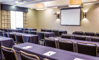 a conference room set up for a meeting , with tables and chairs arranged in rows at Cambria Hotel Appleton