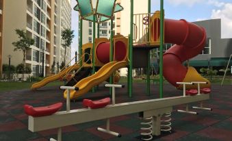 an outdoor playground with a variety of play equipment , including slides , swings , and a jungle gym at KSL Hot Spring Resort