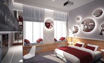 a modern bedroom with a large bed , red and white bedding , and multiple mirrors on the wall at Fabrika