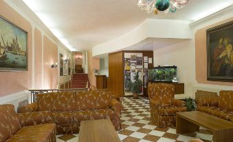 a well - decorated living room with several couches and chairs , creating a cozy atmosphere for guests at Hotel Nazionale