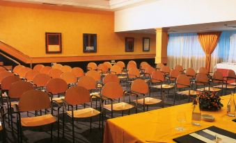 a large conference room with rows of chairs arranged in a semicircle , ready for an event at Hotel Riu Palace Oasis