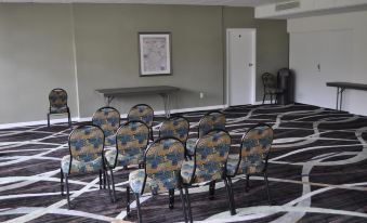a conference room with rows of chairs arranged in a semicircle , ready for a meeting at Ramada by Wyndham Cocoa